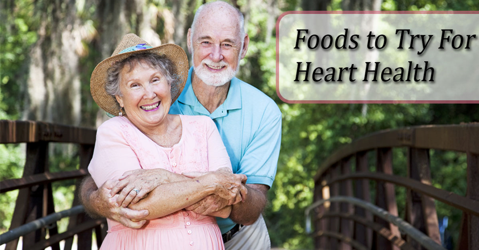 A Caucasian man and woman in a park setting with text "Foods to Try For Heart Health"