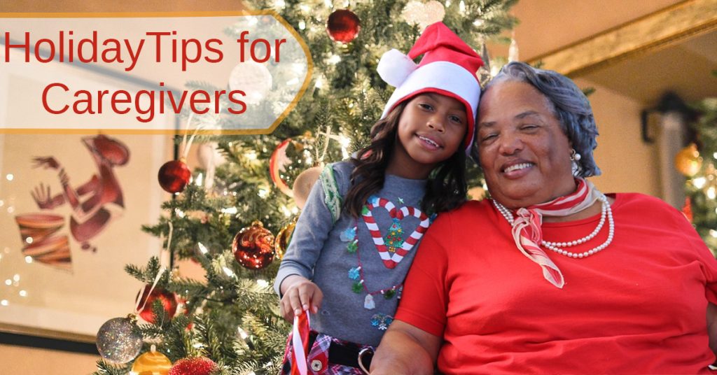 Holidays with Alzheimer's. Grandmother and granddaughter smiling in front of a Christmas tree.