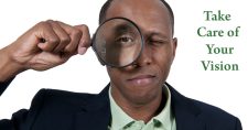Caring for Your Eyes and Vision. Picture of a young black male holding a magnifying glass up to his eye.